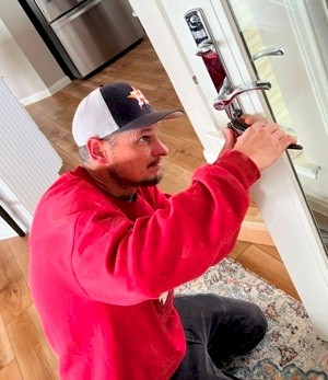 Image of Tracy Calvert crew making fine adjustments to an Andersen door to fix it's action and fit.  Image Copyright © 2023 Brad Larkin
