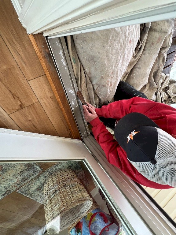 Image of a corroded door jam before repair by Tracy Calvert's crew in a Galveston beach house. Image Copyright © 2023 Brad Larkin