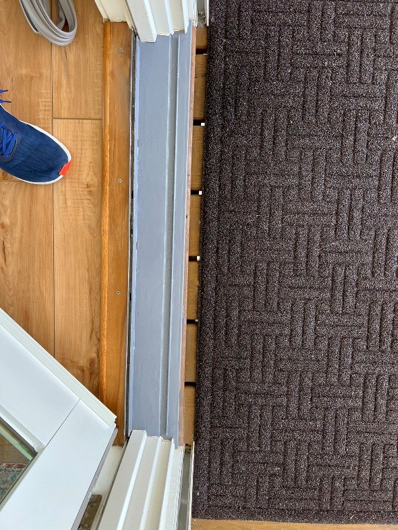 Image of the sanded and painted door after repair by Tracy Calvert's crew in a Galveston beach house. Image Copyright © 2023 Brad Larkin