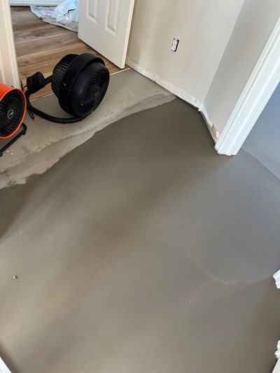 In-progress image of Luxury Vinyl Tile (LVT) flooring going down in a Galveston beach house.  Image Copyright © 2023 Brad Larkin