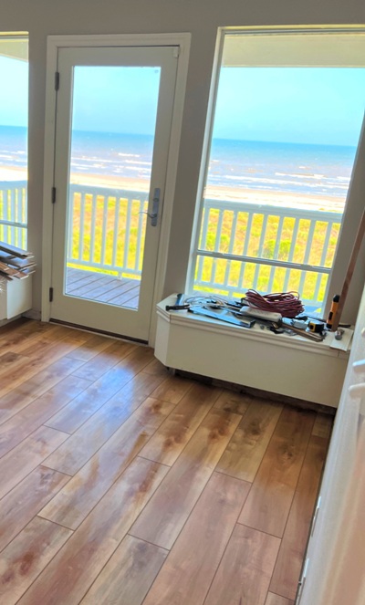 Image of completed laying of Luxury Vinyl Tile (LVT) flooring in a Galveston beach house by Tracy Calvert Home Repair and Maintenance.  Image Copyright © 2023 Brad Larkin