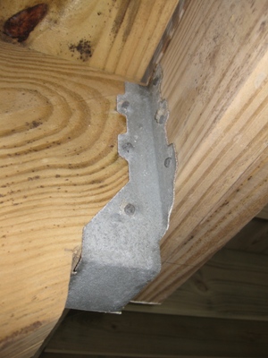 Image of galvanized metal flange which attaches stairs to the rest of the house.  These kind of 'hidden' components must be kept corrosion-free for your safety.  Image Copyright © 2010 Brad Larkin
