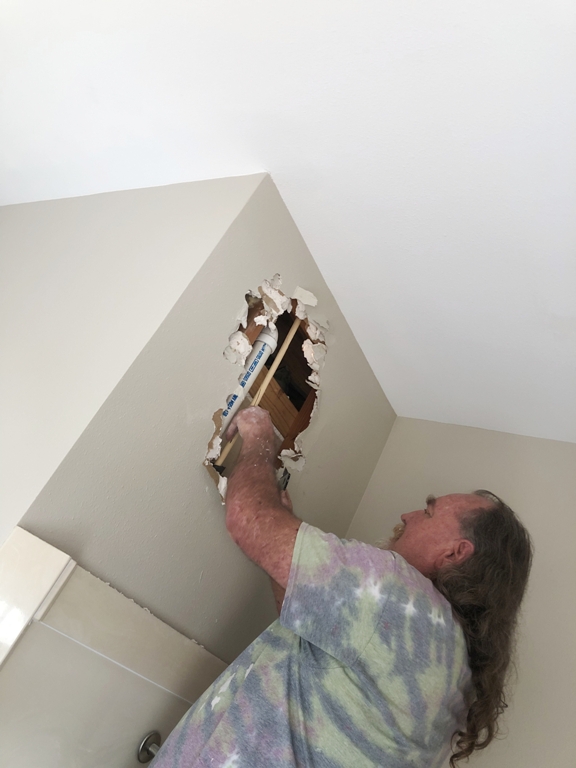 Image of Tracy Calvert Sr searching for the source of a pipe leak following the 2021 Texas freeze. Image Copyright © 2021 Brad Larkin