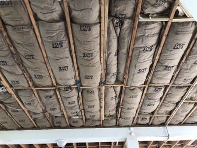 Image of new insulation installed in the subfloor of a Galveston beach house. Image Copyright © 2021 Brad Larkin