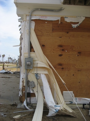 Image of siding damage done on ground level by both surge and wind from Hurricane Ike in 2008.  Image Copyright © 2008 Brad Larkin
