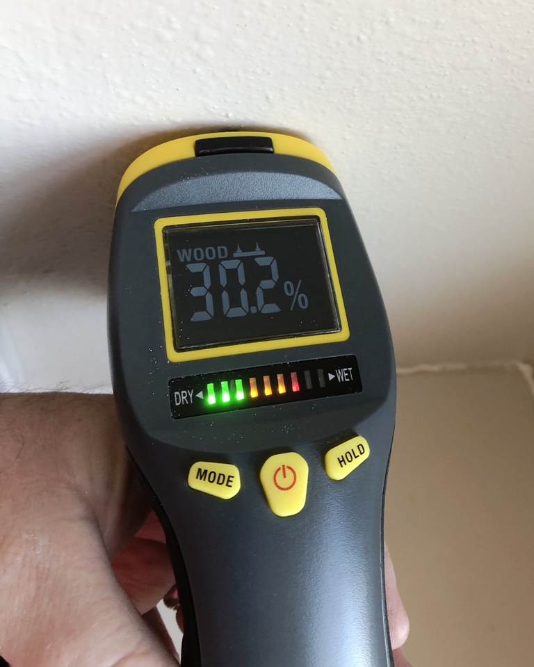 Image of moisture meter being used in Galveston home with water damage from burst pipes during the 2021 Texas Freeze. Image Copyright © 2021 Brad Larkin