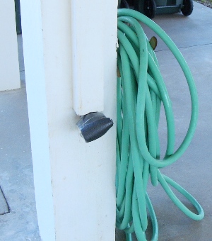 Image of hose bib wrapped with foam pipe insulation and hose disconnected as part of winterizing a Galveston beach house.  Image Copyright © 2010 Brad Larkin